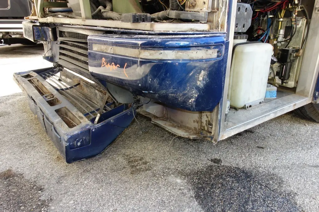 During: damaged front structure stripped back in the Excalibur Coach body shop