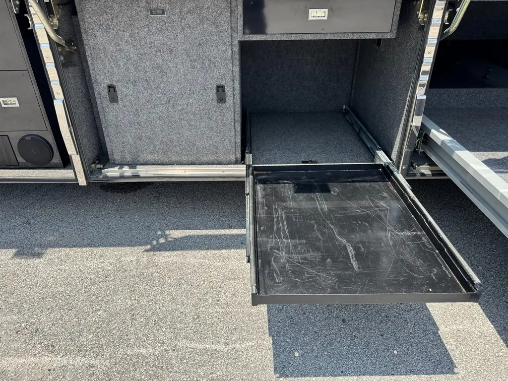 Open storage bay with slide-out tray on the 1999 Vogue Prevost XL