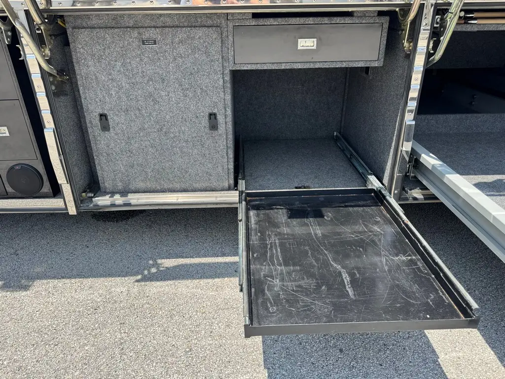 Twin slide-out trays in the storage bays of the 1999 Vogue Prevost XL